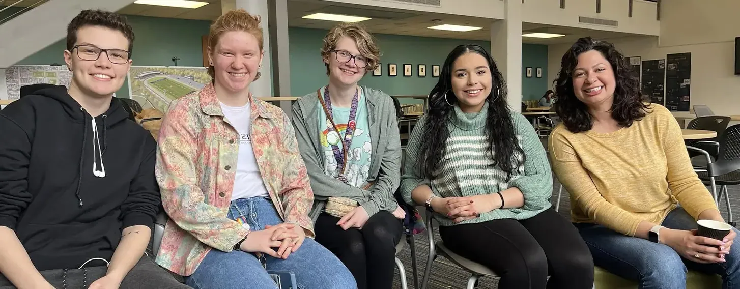 A group of students posing at an inside campus event